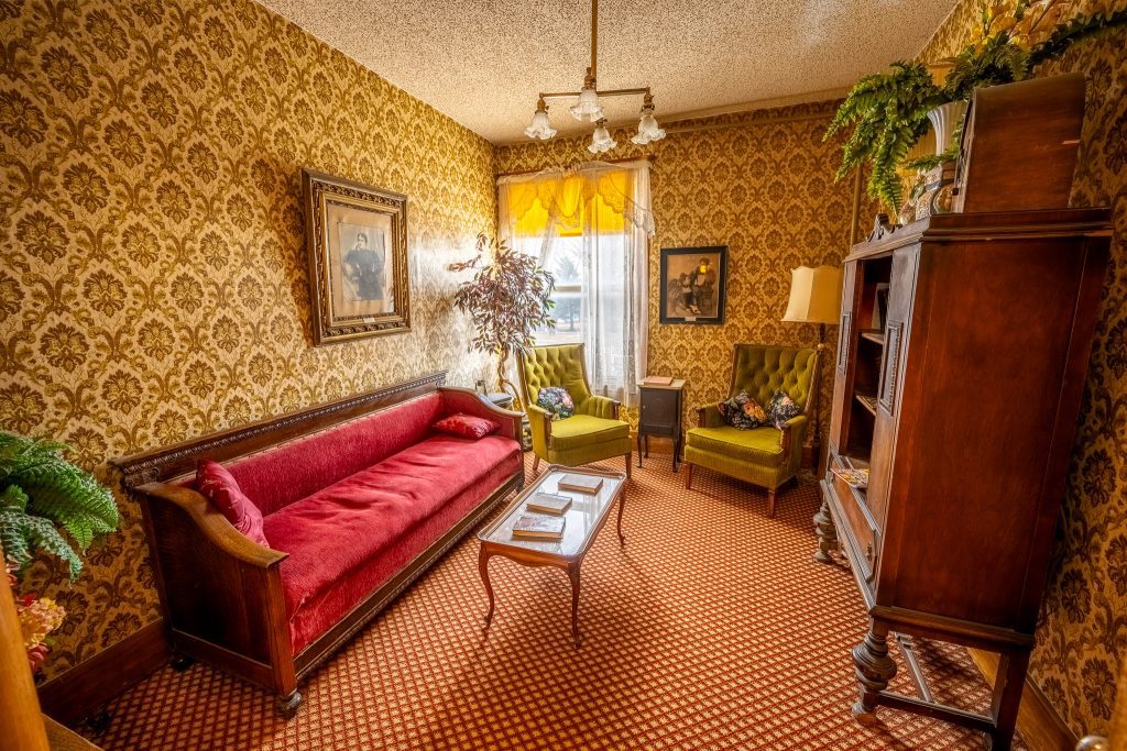 An elegant looking historic room with fine furniture.